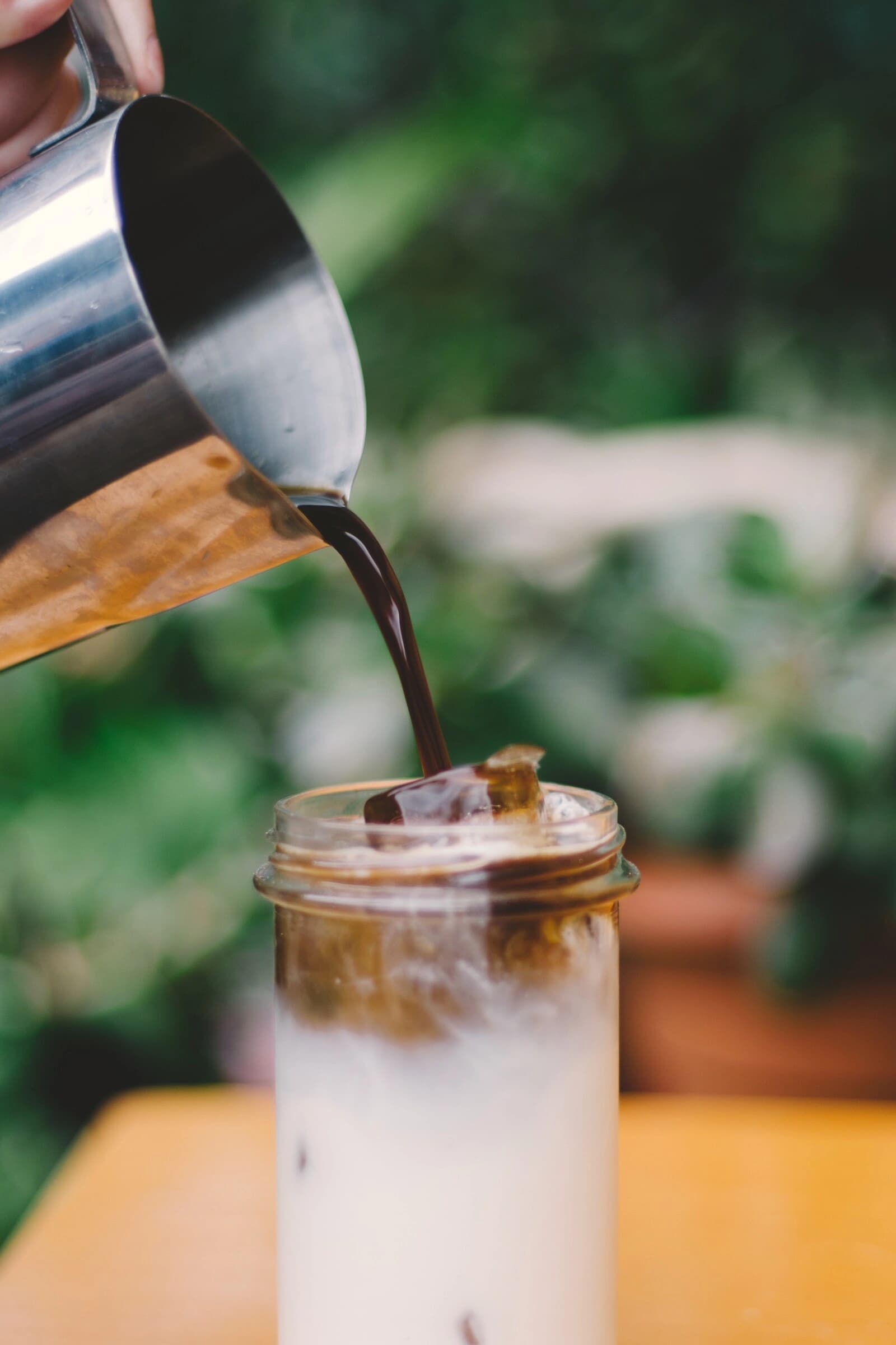 Iced coffee poured over milk